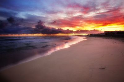 Scenic view of beach against sky during sunset