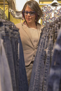 Woman shopping jeans in store