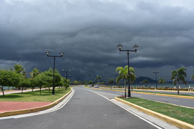 Empty road against cloudy sky