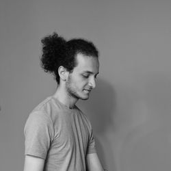 Portrait of smiling young man against white background