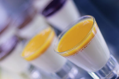 Close-up of yellow cup on table