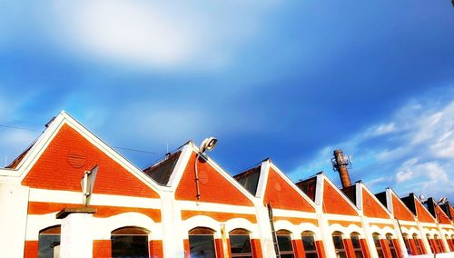 Low angle view of building against cloudy sky