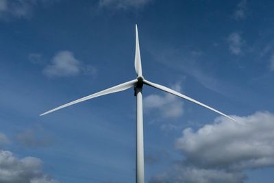 Low angle view of wind turbine against sky