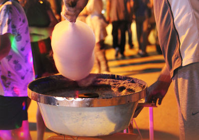 Close-up of people preparing food outdoors