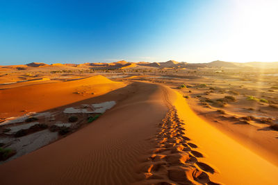 Scenic view of desert against clear sky