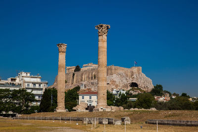 Ruins of the temple of olympian zeus also known as the olympieion and the acropolis in athens 