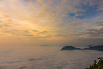 Scenic view of mountains against cloudy sky