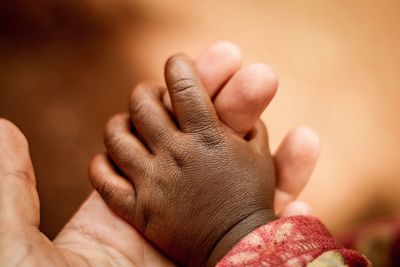 Close-up of mother and son's hands