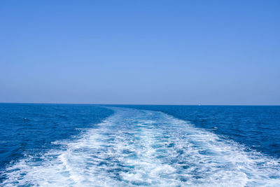 Scenic view of sea against clear blue sky