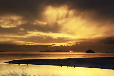 Scenic view of beach against sky during sunset