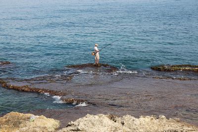 Full length of man standing on beach