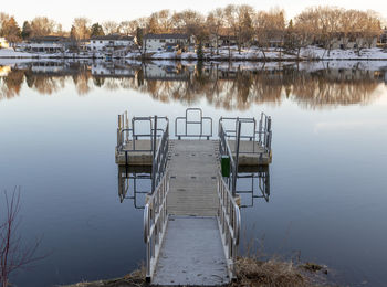 Pier on lake against trees