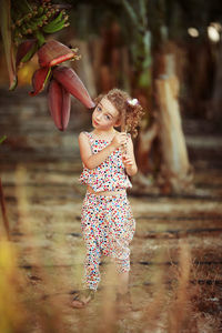 Portrait of smiling woman standing outdoors