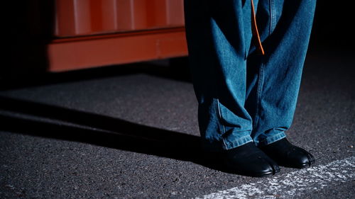 Low section of man standing on street