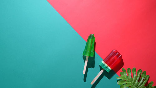 High angle view of colored pencils on table against wall