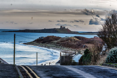 A view of dunstanburgh castle from high newton in northumberland