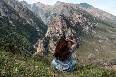 Rear view of young woman looking at mountain