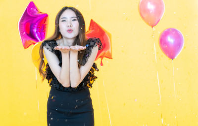 Portrait of a beautiful young woman with balloons