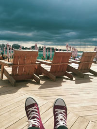 Low section of woman sitting on beach