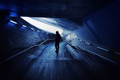 Woman walking in tunnel