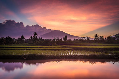 Scenic view of lake against sky during sunset