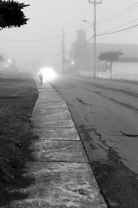 Person walking on footpath in city