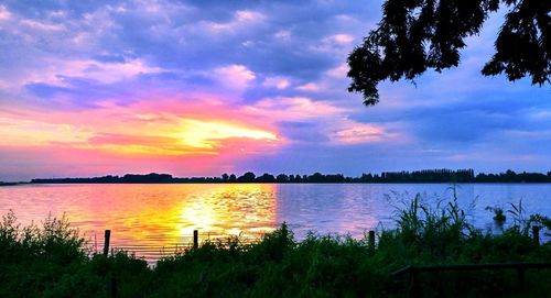 Scenic view of lake against sky during sunset