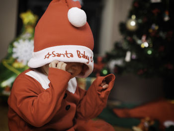 Close-up of child in santa claus costume