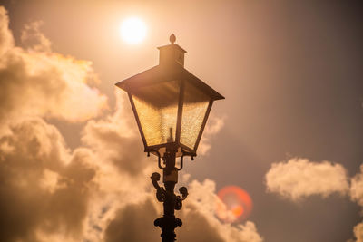 Lens flare in street lantern against the sun.