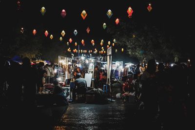 People in illuminated city at night