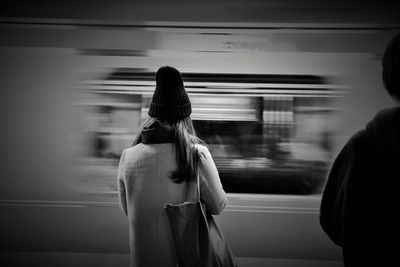 Rear view of woman looking at camera