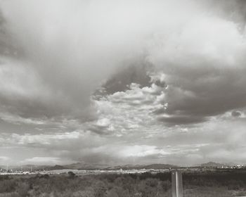 Scenic view of landscape against cloudy sky