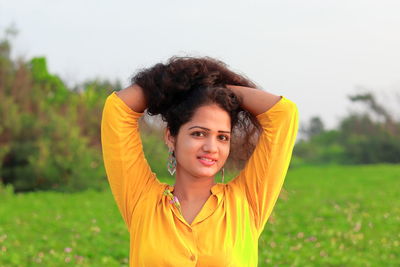 Portrait of smiling young woman on field