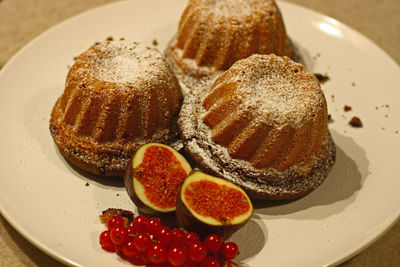 Close-up of cake figs red currant in plate on table