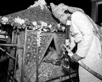 Side view of woman working on barbecue grill