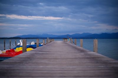 Wooden pier over sea against sky