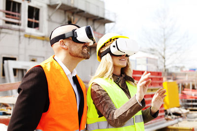Two persons with virtual reality glasses at construction site