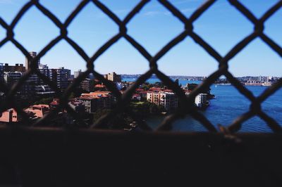 Cityscape seen through chainlink fence