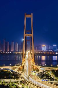 Illuminated bridge at night