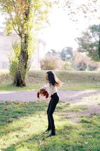 Side view of woman standing on field