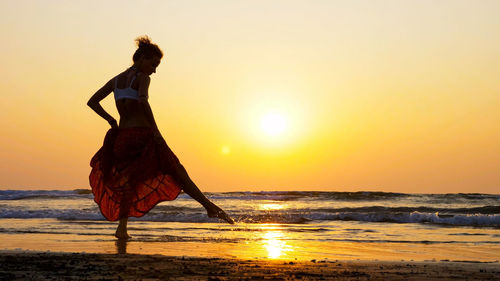 Woman on beach during sunset