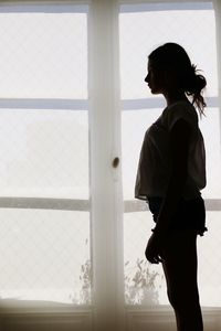 Woman standing by window