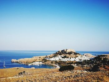 Panoramic view of sea against clear blue sky