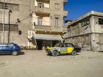 Motorcycle parked on road against buildings in city