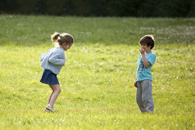 Full length of boy standing on grassy field