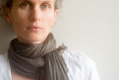 Close-up portrait of young woman against white background