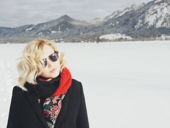 Young woman standing on snow covered landscape