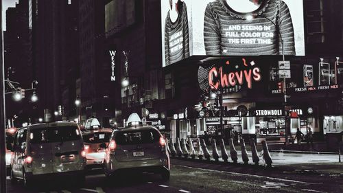 Cars on city street at night