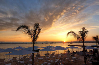 Scenic view of beach against sky during sunset