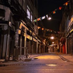 Illuminated city street at night